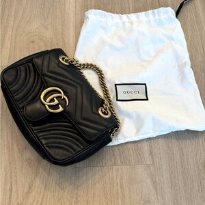 Gucci Black GG Marmont small shoulder bag with gold hardware.